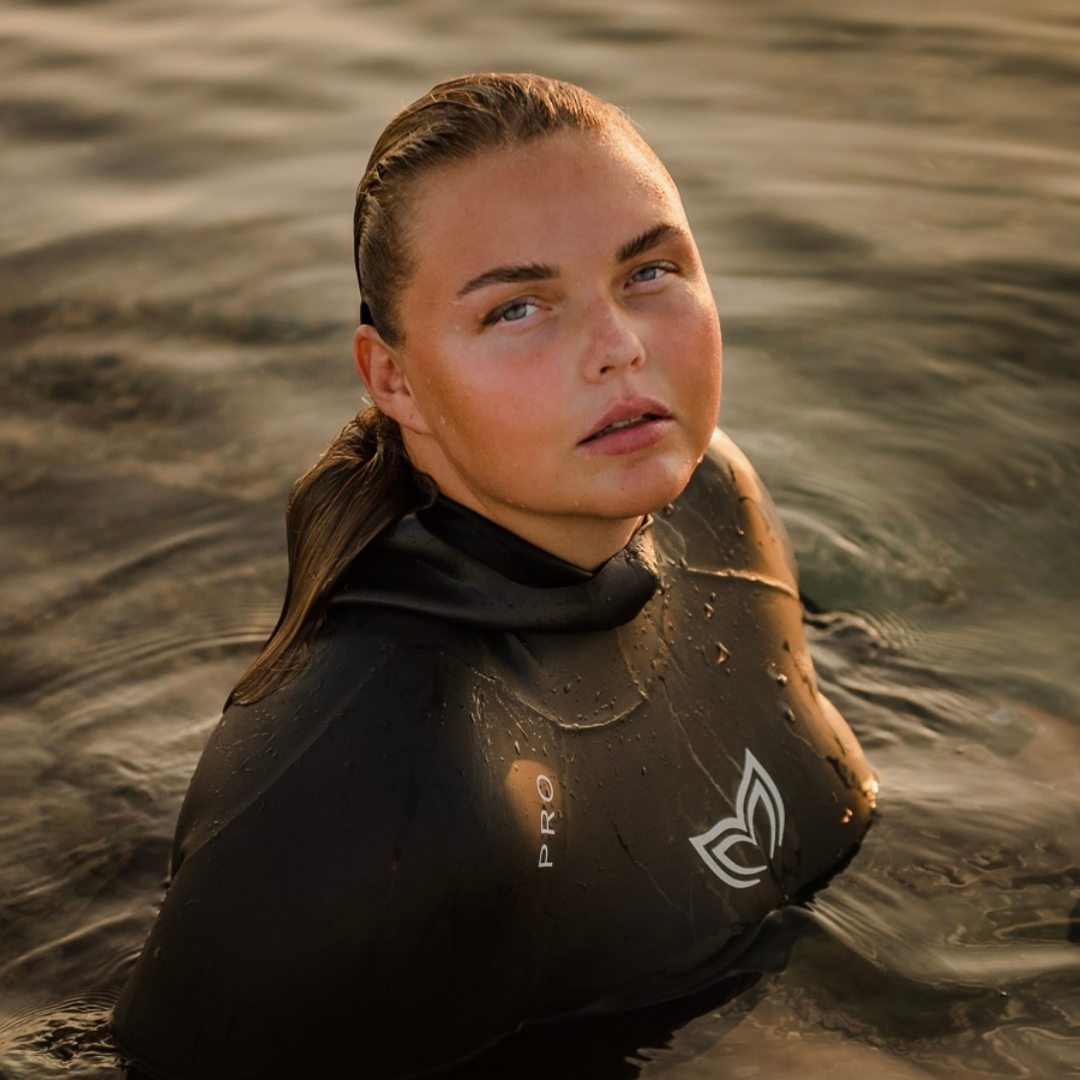 Female freediver wearing a womens cut fredddiving wetsuit while exploring a reef