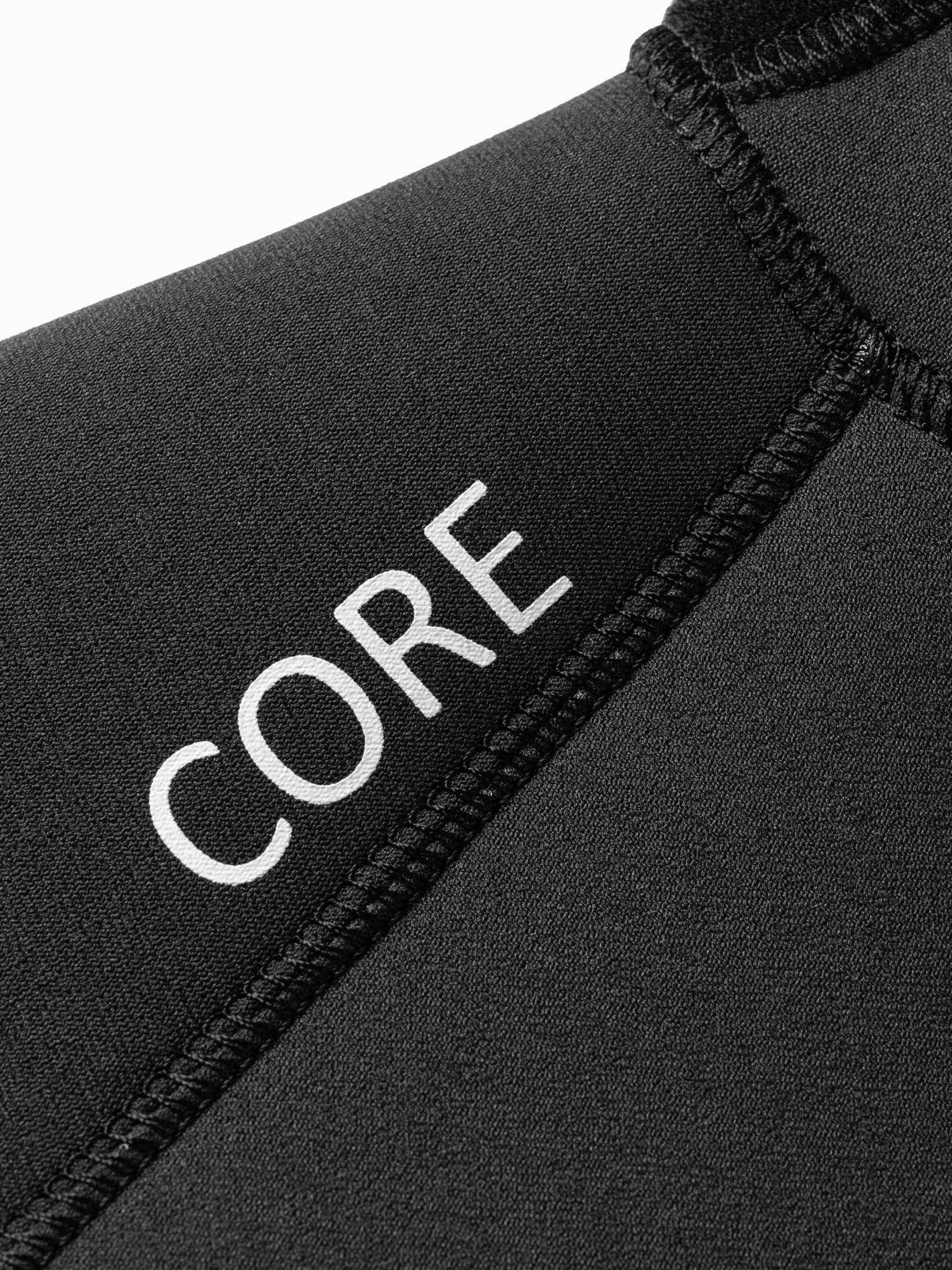 Close up of the CORE logo on the shoulder of the mens one piece wetsuit
