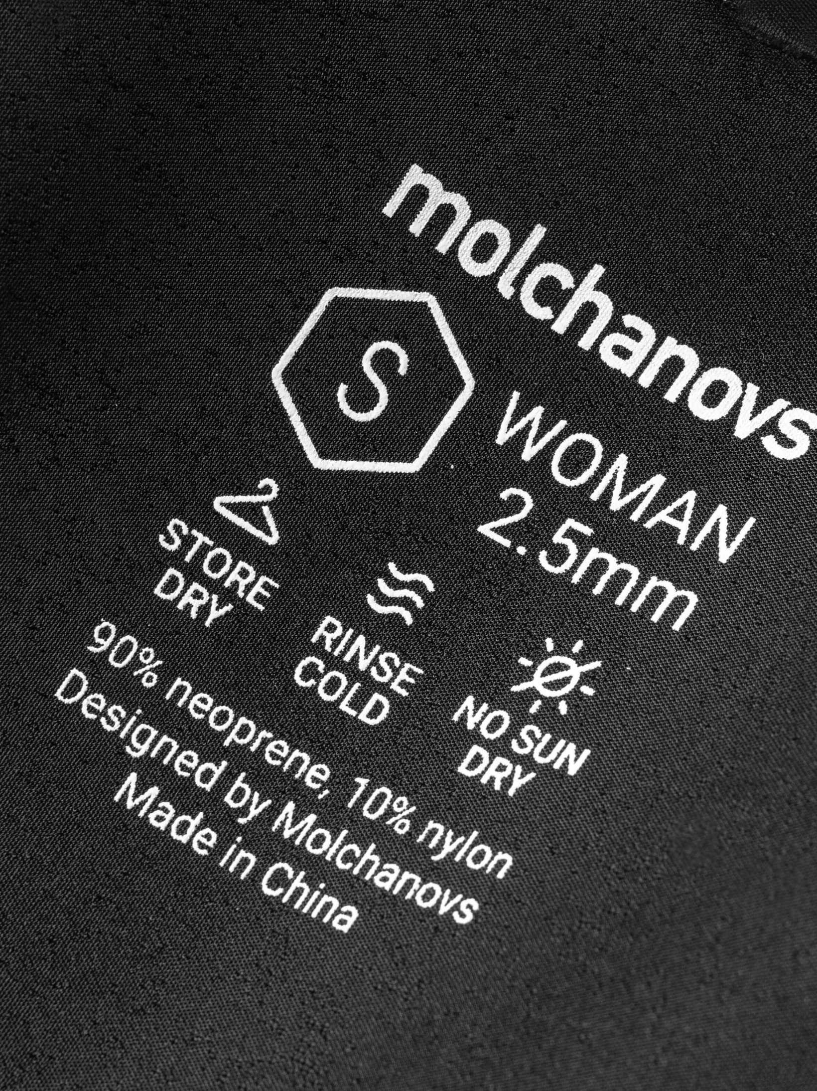 Close up of sizing, neoprene thickness and care instruction for this mens wetsuit